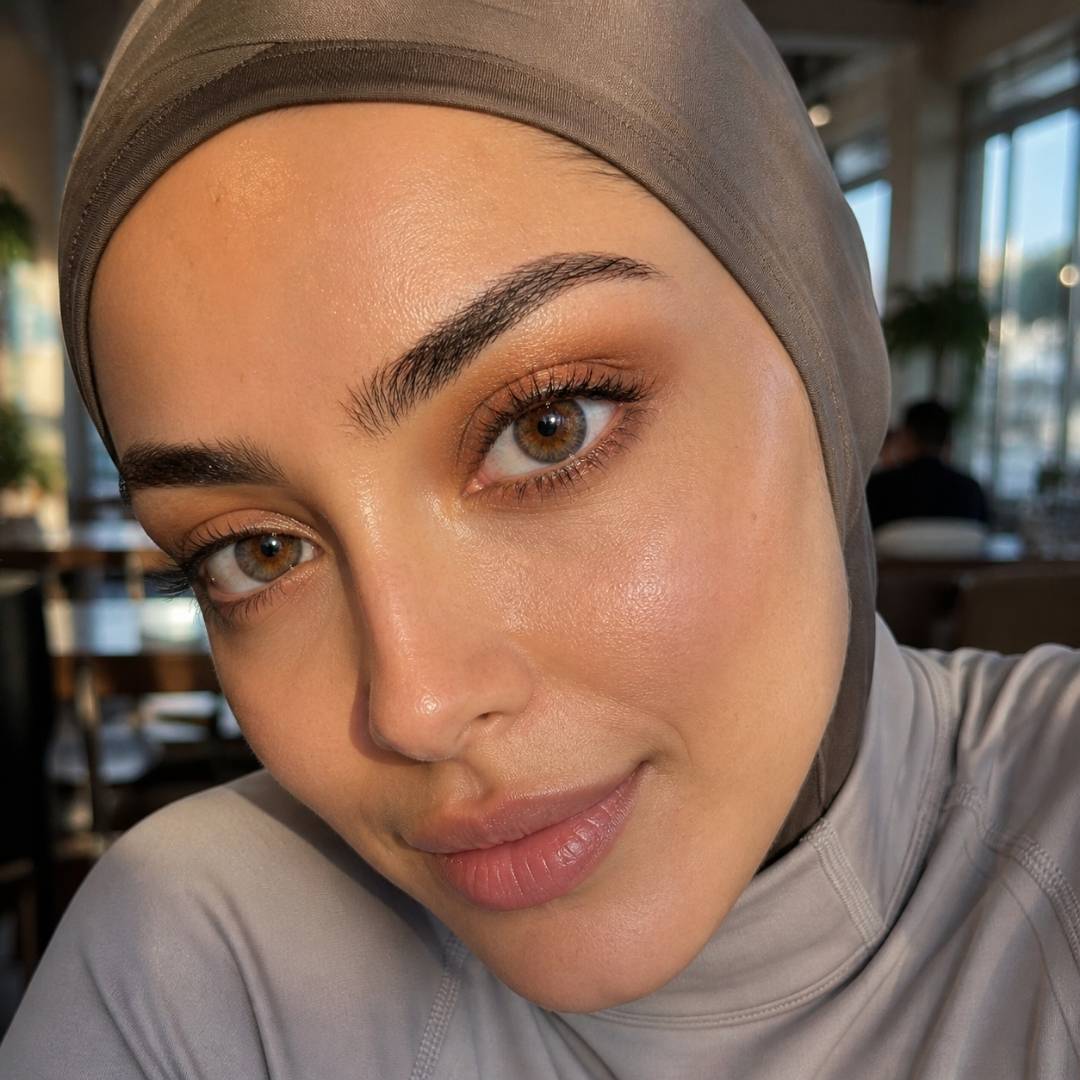 Woman wearing a hijab with a blurred indoor background