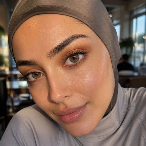 Woman wearing a hijab with a blurred indoor background