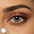 single eye wearing subtle gray color contacts