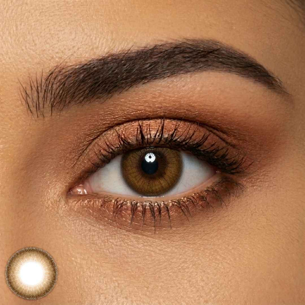 Close-up of subtle honey brown contacts on dark brown eyes with soft glam makeup