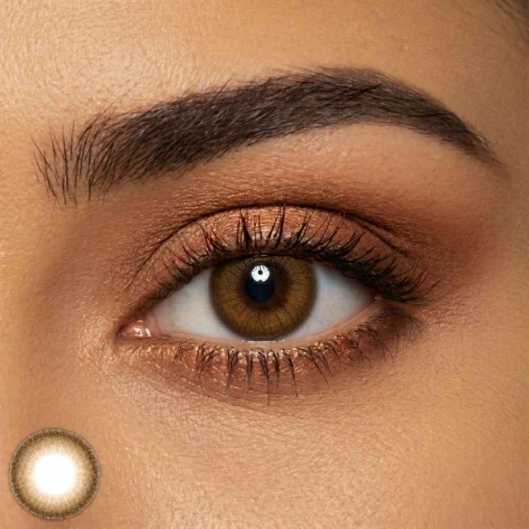 Close-up of subtle honey brown contacts on dark brown eyes with soft glam makeup