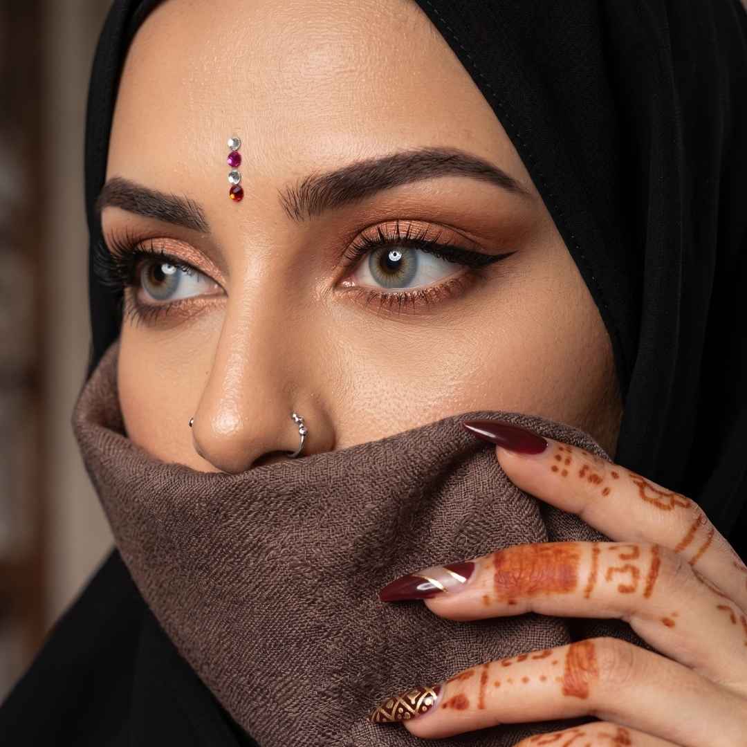 A woman wearing a black headscarf and a ring, with striking coco gray contact lenses enhancing her gaze.