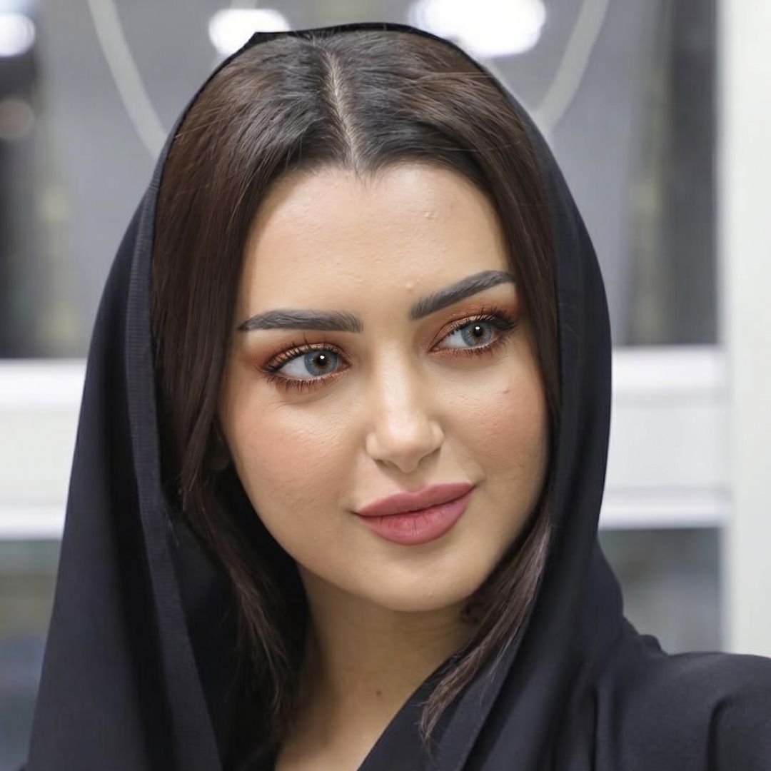 A woman in a black shawl and headscarf, with striking coco gray contact lenses, exudes elegance and mystery.