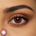 Close-up of a person's eye with a red contact lens