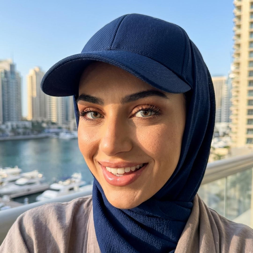 dubai girl wearing gray contacts, blue cap and hijab