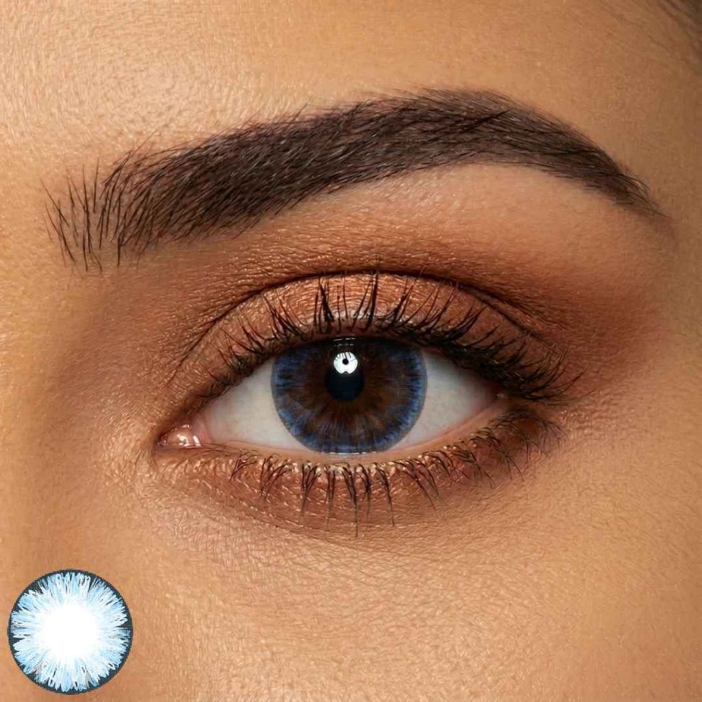 Close-up of a person's eye with a contact lens inset showing a blue color.