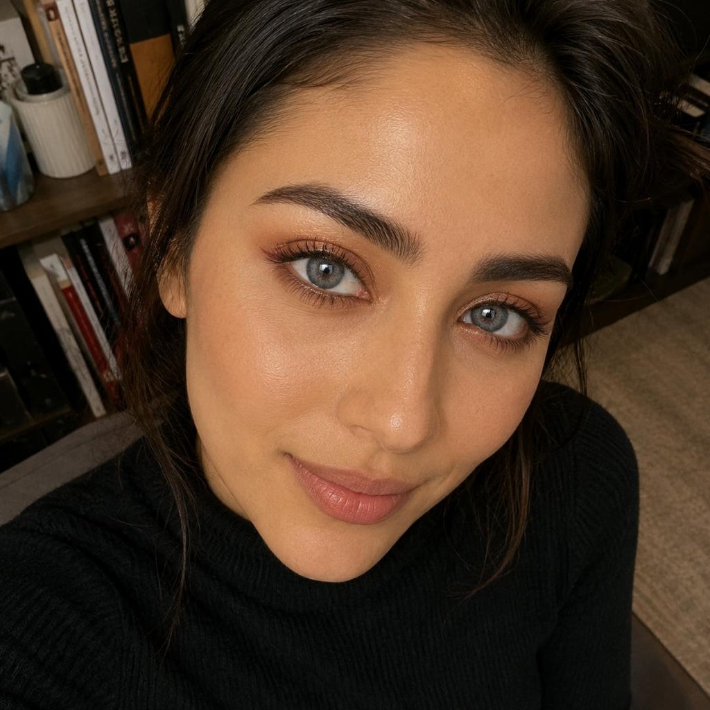 A woman with dark brown eyes wearing a black top, enhanced by coco gray contact lenses.